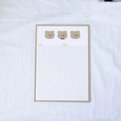 Cartoon sticky note pad in avocado or bear design, showing large and small size options next to a pen.