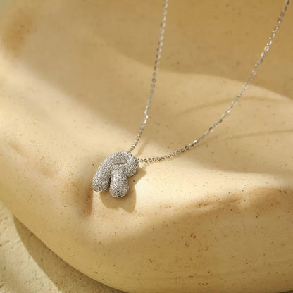 Stainless steel initial pendant necklace with zircon accents, personalized with your choice of letter.