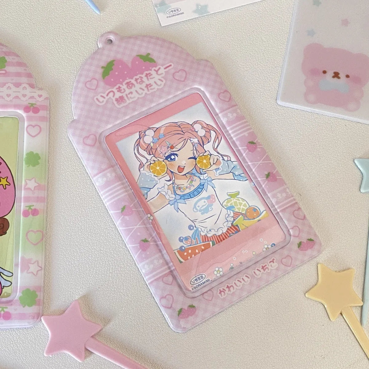 Cartoon plaid strawberry PVC card holder measuring 7.6 by 13.6 centimetres with lanyard attachment