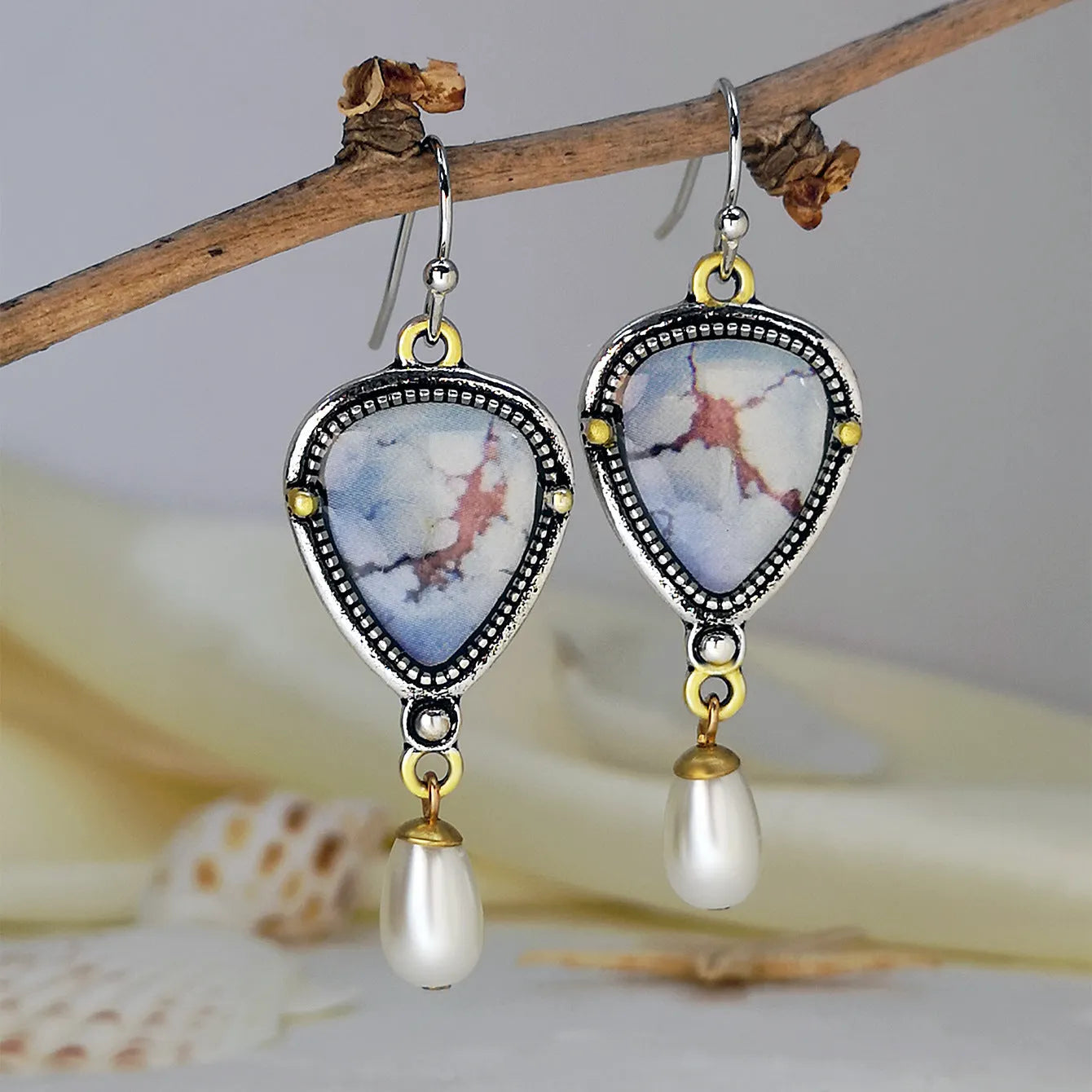 Retro blue geometric drop earrings with synthetic opal and pearl detail on a metal base.