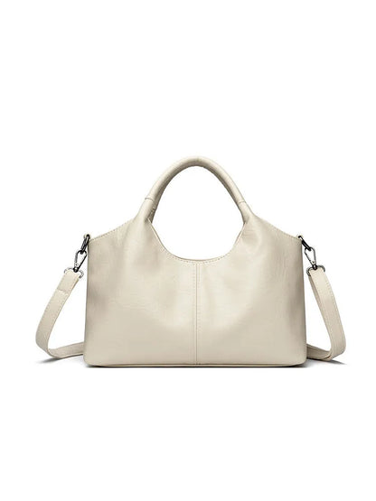 Soft genuine leather women's crossbody bag in beige with large capacity and adjustable strap.