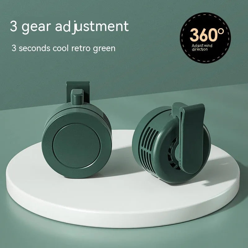 Green wrist hanging fan with light and USB power bank on a person's arm, showing three speed buttons.