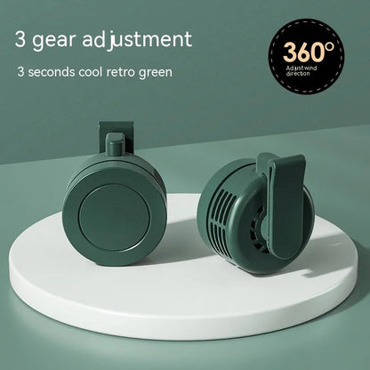 Green wrist hanging fan with light and USB power bank on a person's arm, showing three speed buttons.