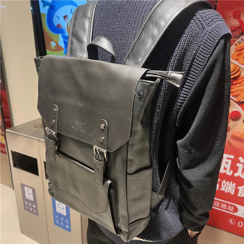 Unisex large capacity PU backpack in a solid colour, shown in college style.