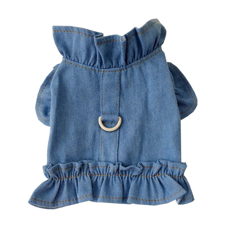 Blue denim dog dress with ruffles and integrated harness for leash attachment.