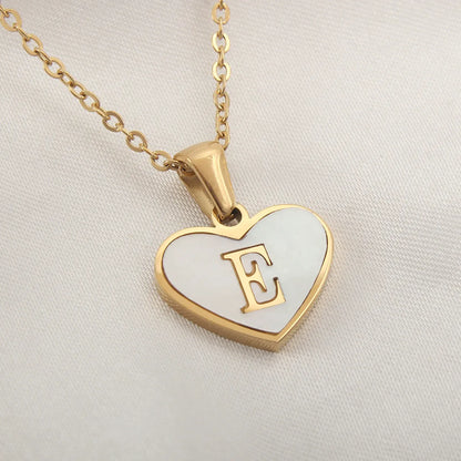 Gold-plated clavicle necklace with a white shell heart pendant, personalised with a letter from A to Z.