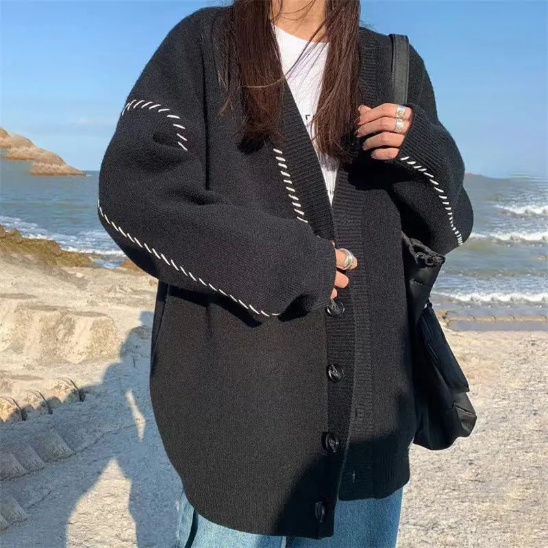 Women's knitted cardigan top coat in black or white, loose fit with long sleeves, made from 100% polyester
