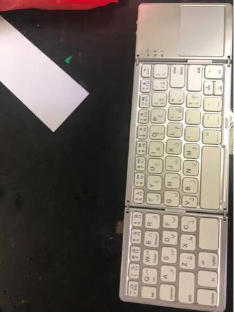 Tri-fold folding touch keyboard shown both unfolded for typing and folded for transport with touchpad