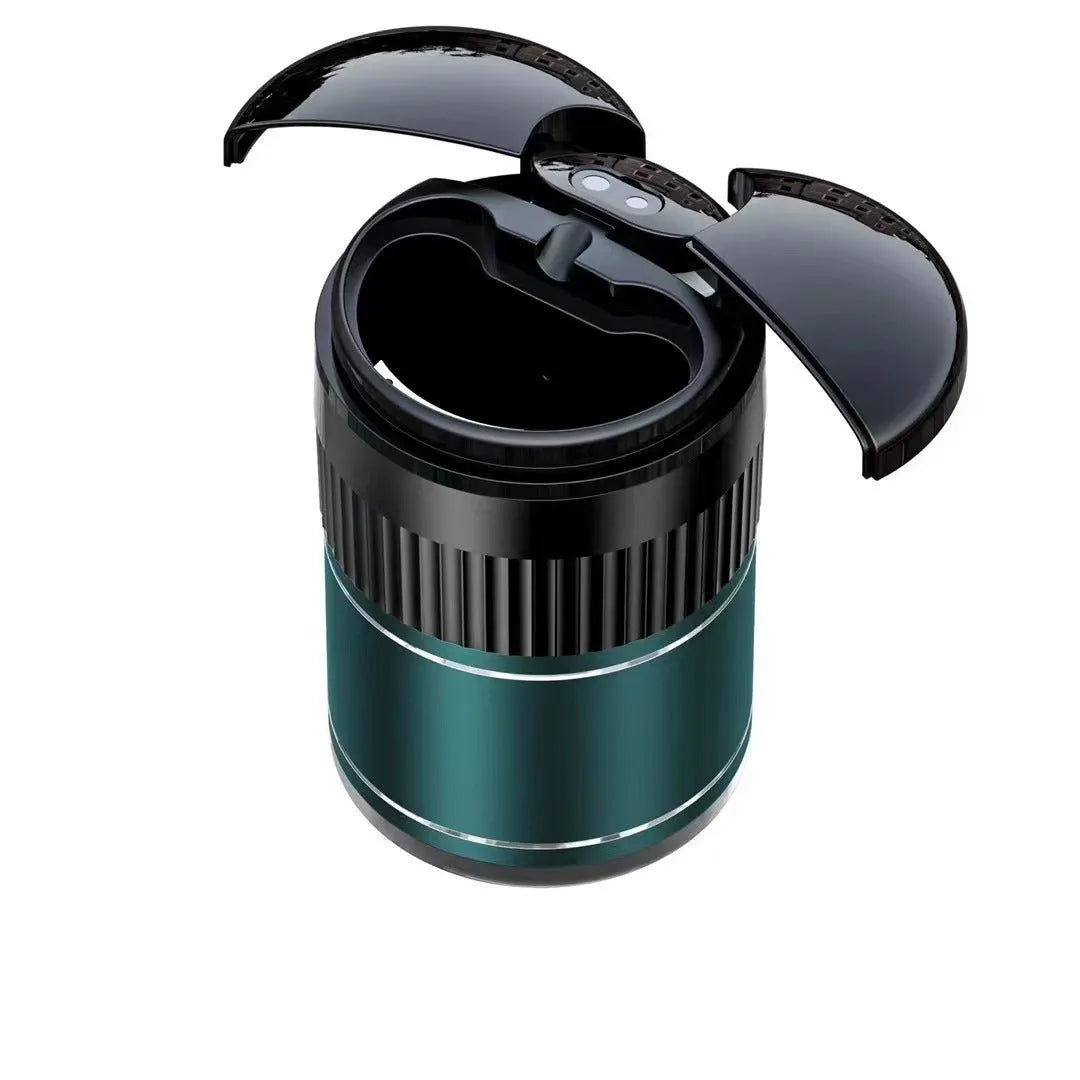 Compact black metal car ashtray with automatic lid on a car console