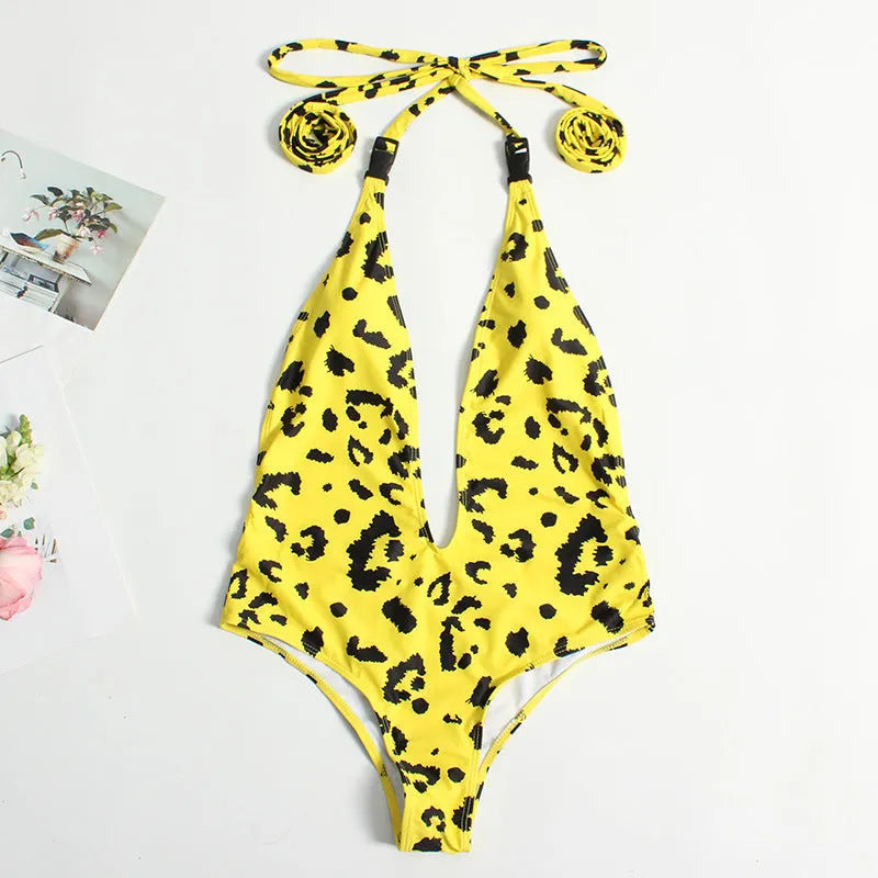 Backless leopard print one-piece swimsuit for women with a front buckle and bandage style design.