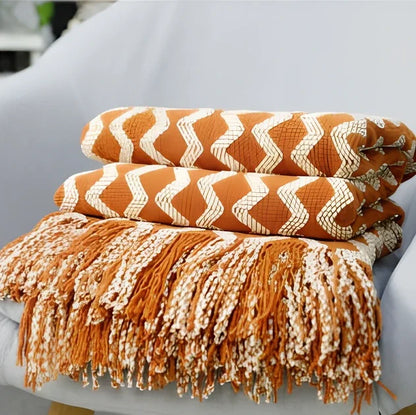 Nordic knitted decorative blanket with striped pattern and tassels in light grey colour