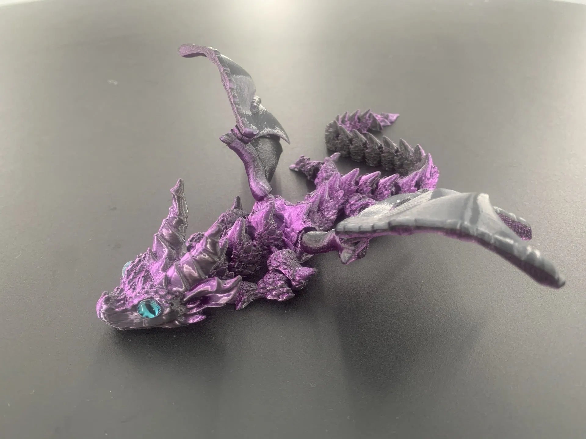 Red and gold 3D printed plastic dragon wings decoration for costumes.