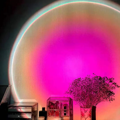 Rechargeable sunset projection lamp showing red and rainbow colours on wall