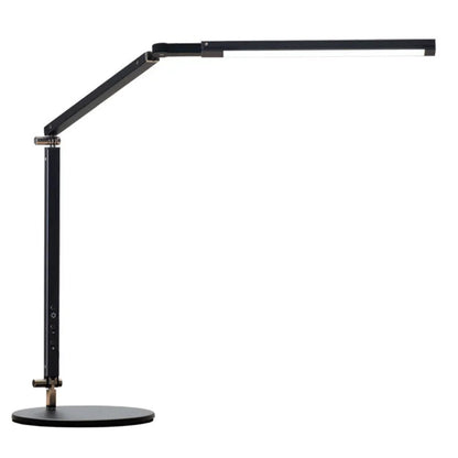 Clip-on adjustable arm LED desk lamp in black mounted on a desk edge with remote control.