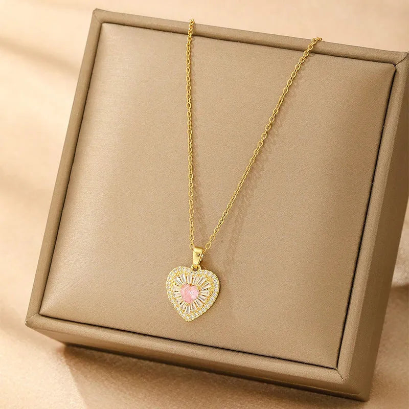 Women's gold electroplated copper necklace showing four pendant options: heart, butterfly, cross and round diamond