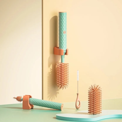 Electric baby bottle cleaning brush with rotating silicone head in pink or green colours