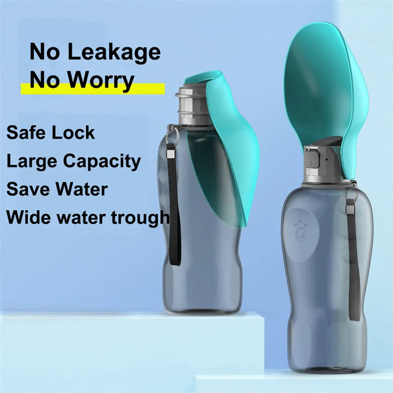 Blue grey portable dog water bottle with foldable drinking bowl and wrist strap, shown next to a dog.