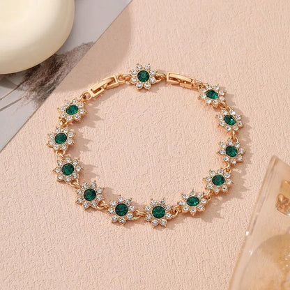 Floral shaped zinc alloy bracelet with electroplated colourful gem finishes in gold and silver tones.