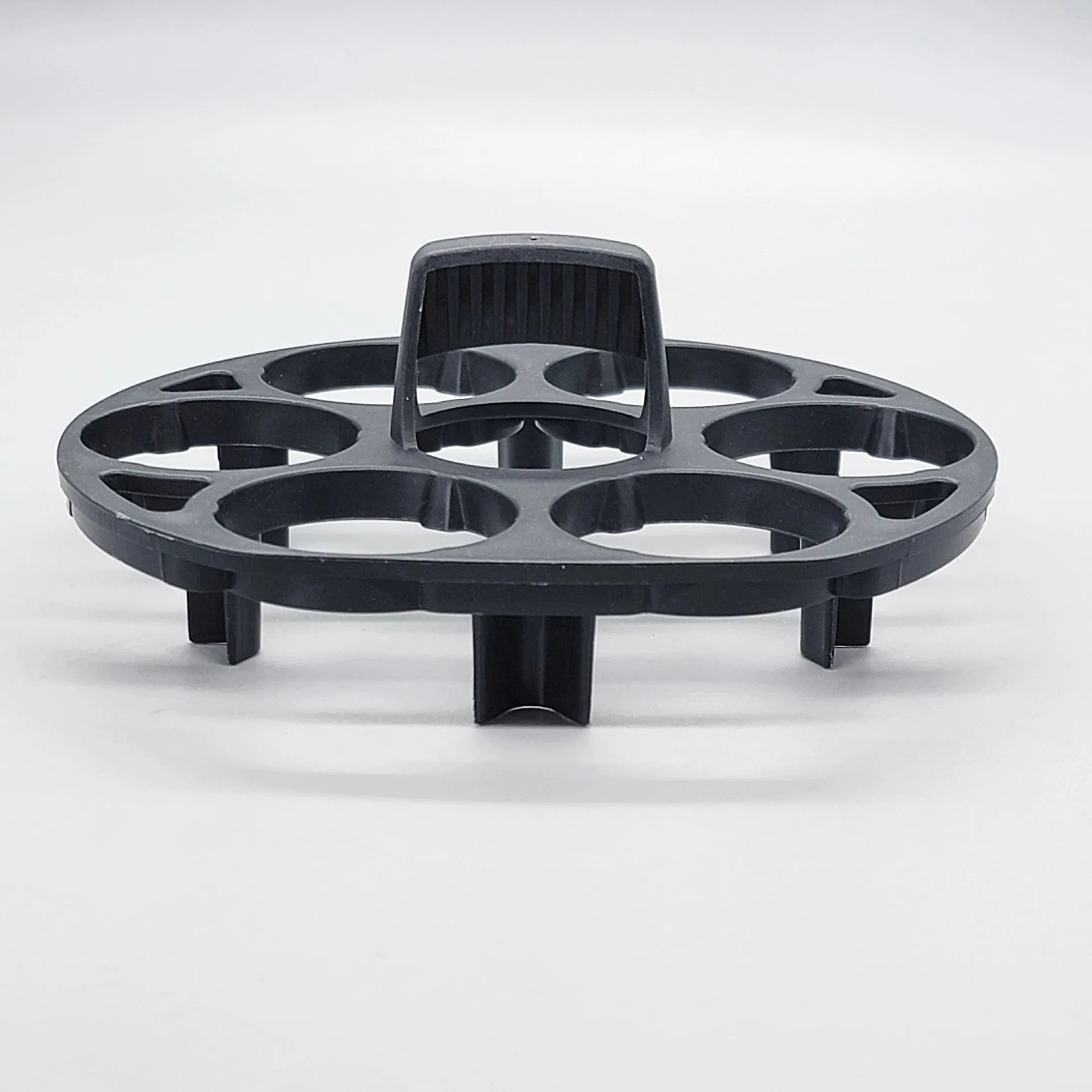 Black plastic egg holder rack for a cooking machine, shown from above.