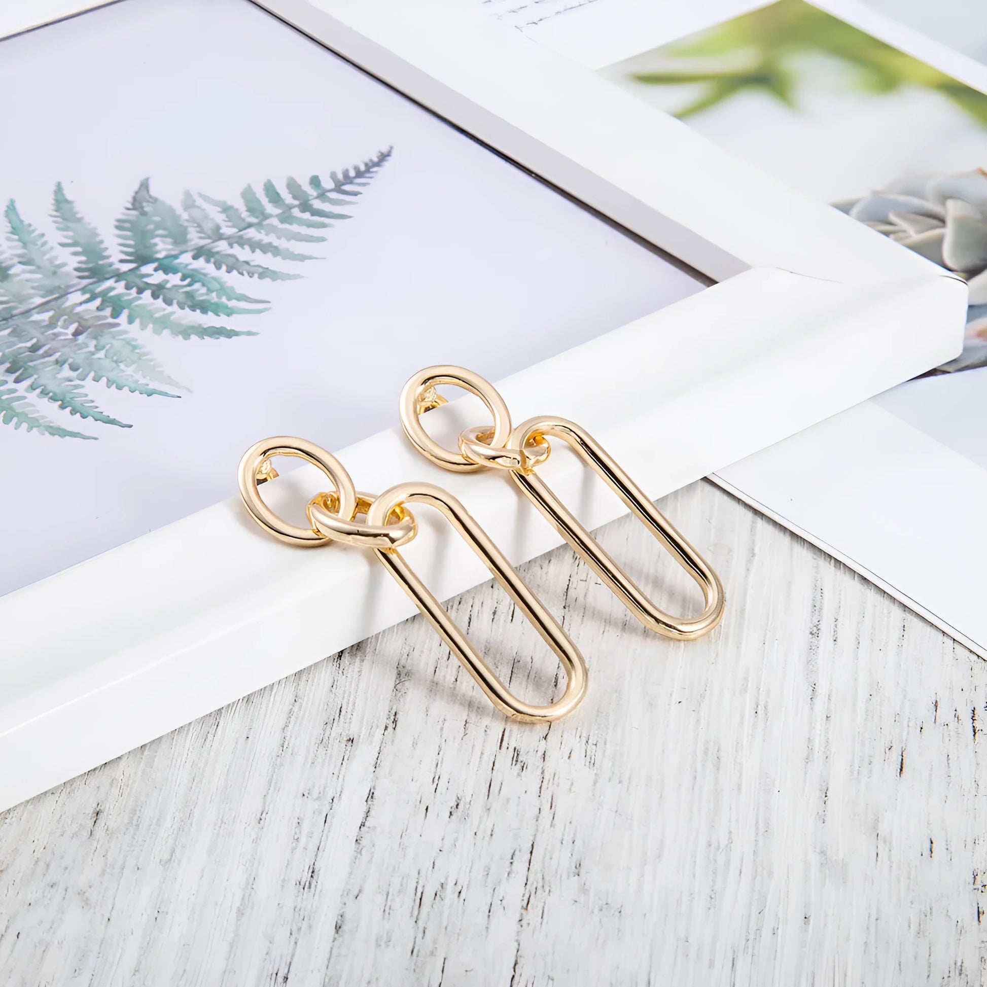 Geometric sterling silver needle finish hoop earrings showing ring and line design elements