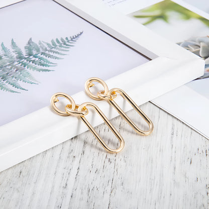 Geometric sterling silver needle finish hoop earrings showing ring and line design elements