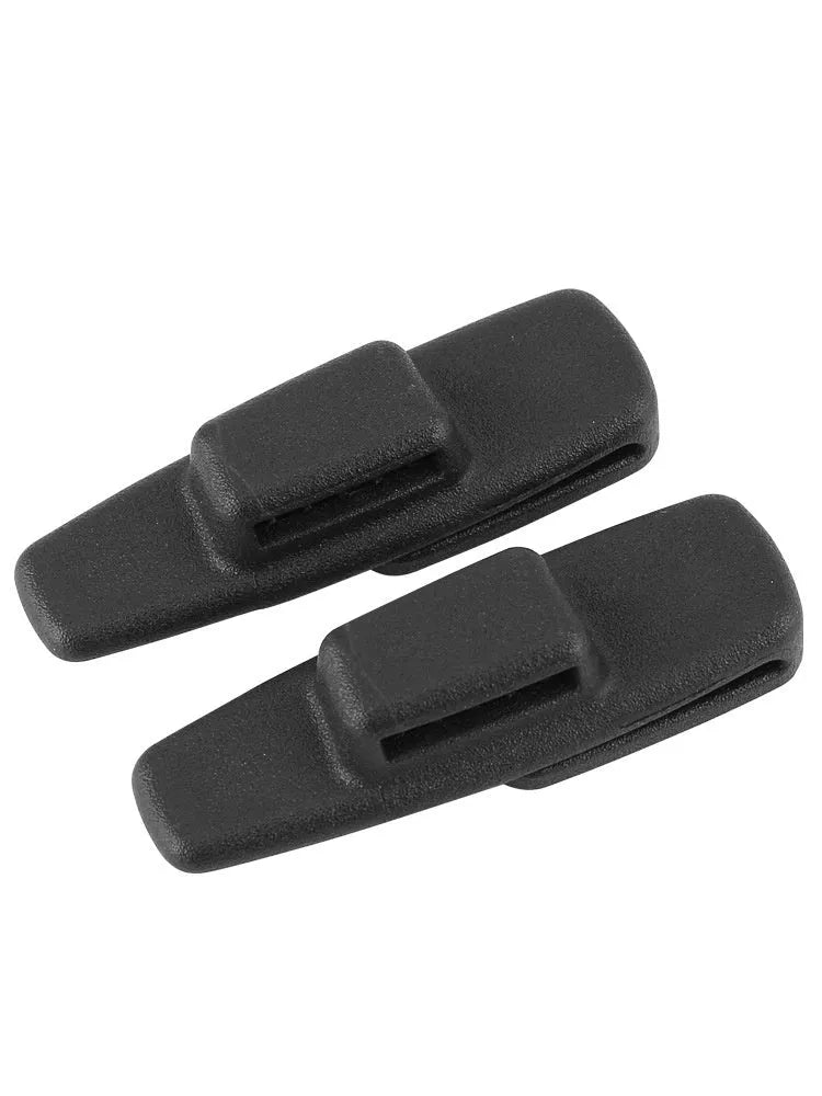 Two black ABS plastic car seat belt stopper clips on a clear OPP bag.