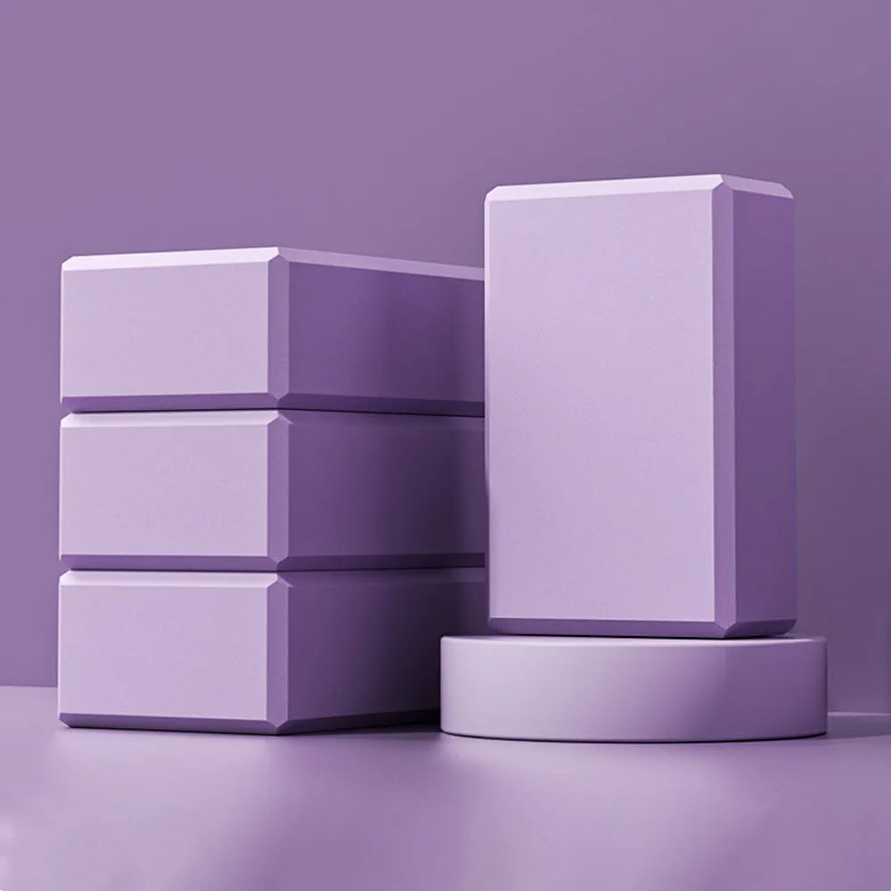 Blue EVA foam yoga block on a yoga mat, showing 23x15x7.6cm dimensions and textured surface for grip
