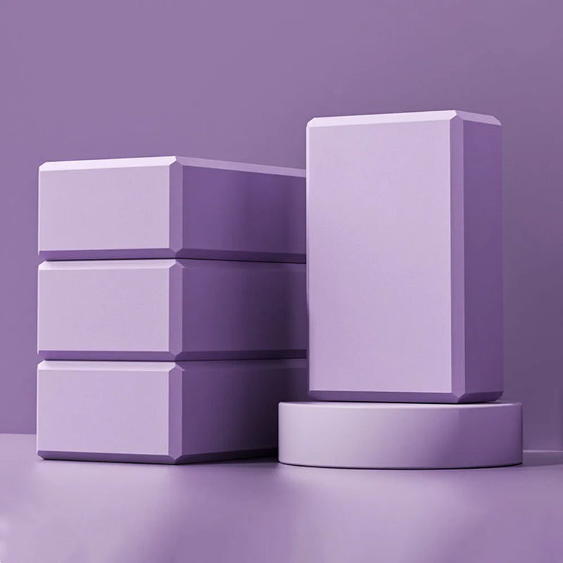 EVA foam yoga block measuring 23x15x7.6cm, providing stable support for poses like triangle and half moon, with a high-density, moisture-resistant construction for secure grip during workouts.