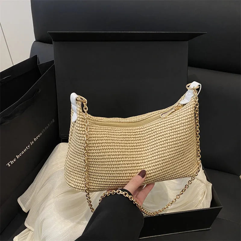 Woven straw shoulder tote bag in a horizontal square shape with a sandwich pocket.