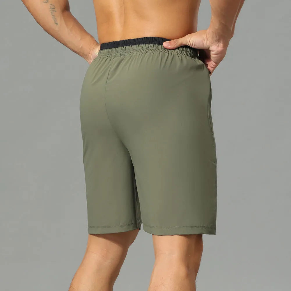 Men's loose grey ice silk cropped running pants showing the fifth pants length and relaxed fit.