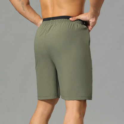 Men's loose grey ice silk cropped running pants showing the fifth pants length and relaxed fit.