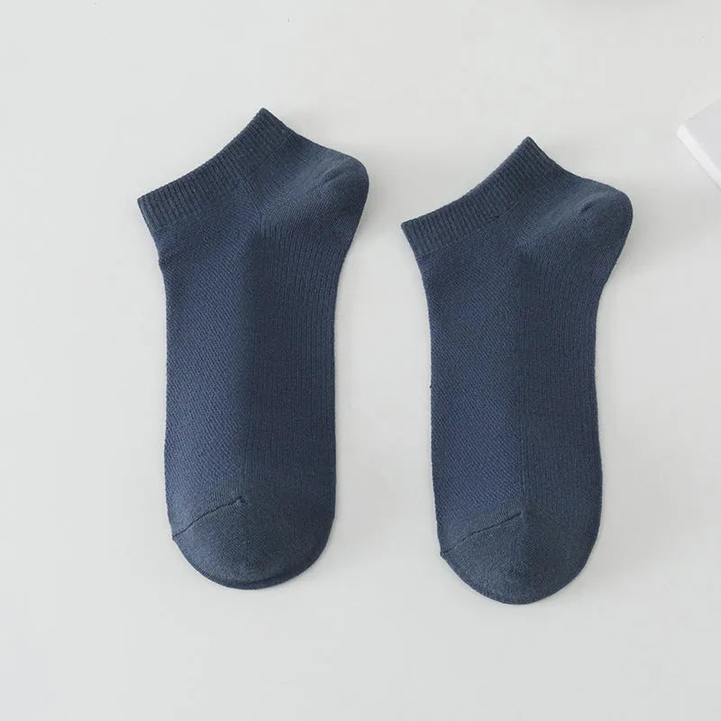 Pair of solid colour low-cut polyester boat socks for men, shown in one of six available colour options.