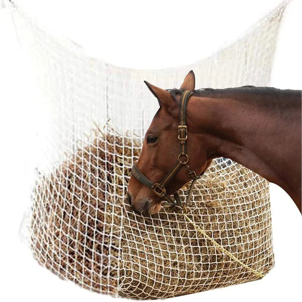 Black woven grid hanging feeding bag for horses, shown against a stable background.