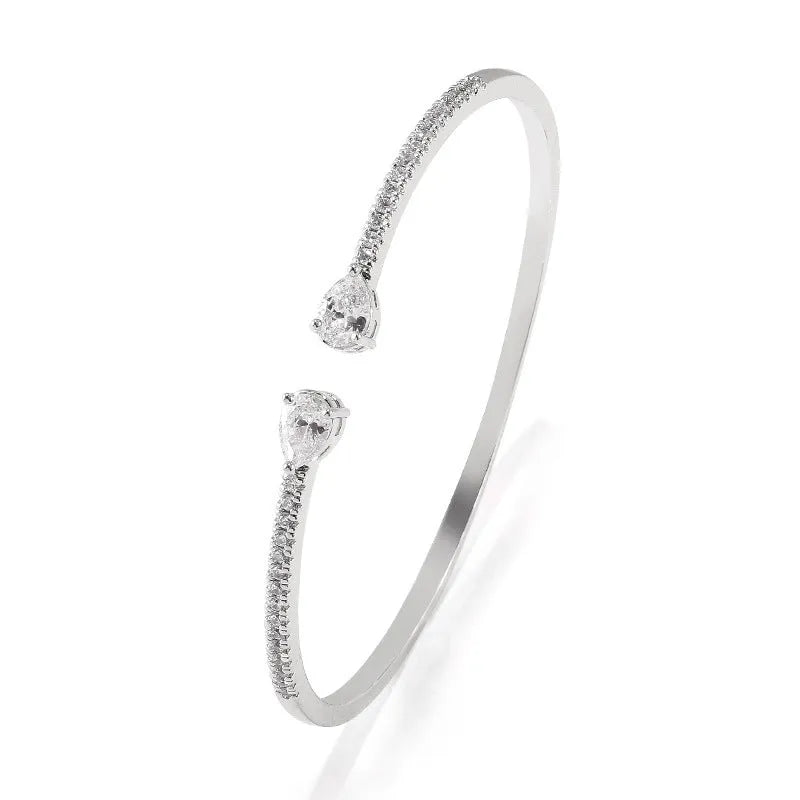 Close-up of a multi-zircon inlay fashion bracelet in copper, shown in blue and white colour options.