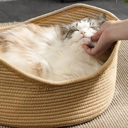 Natural wicker cat basket with integrated corrugated cardboard scratching panel side.
