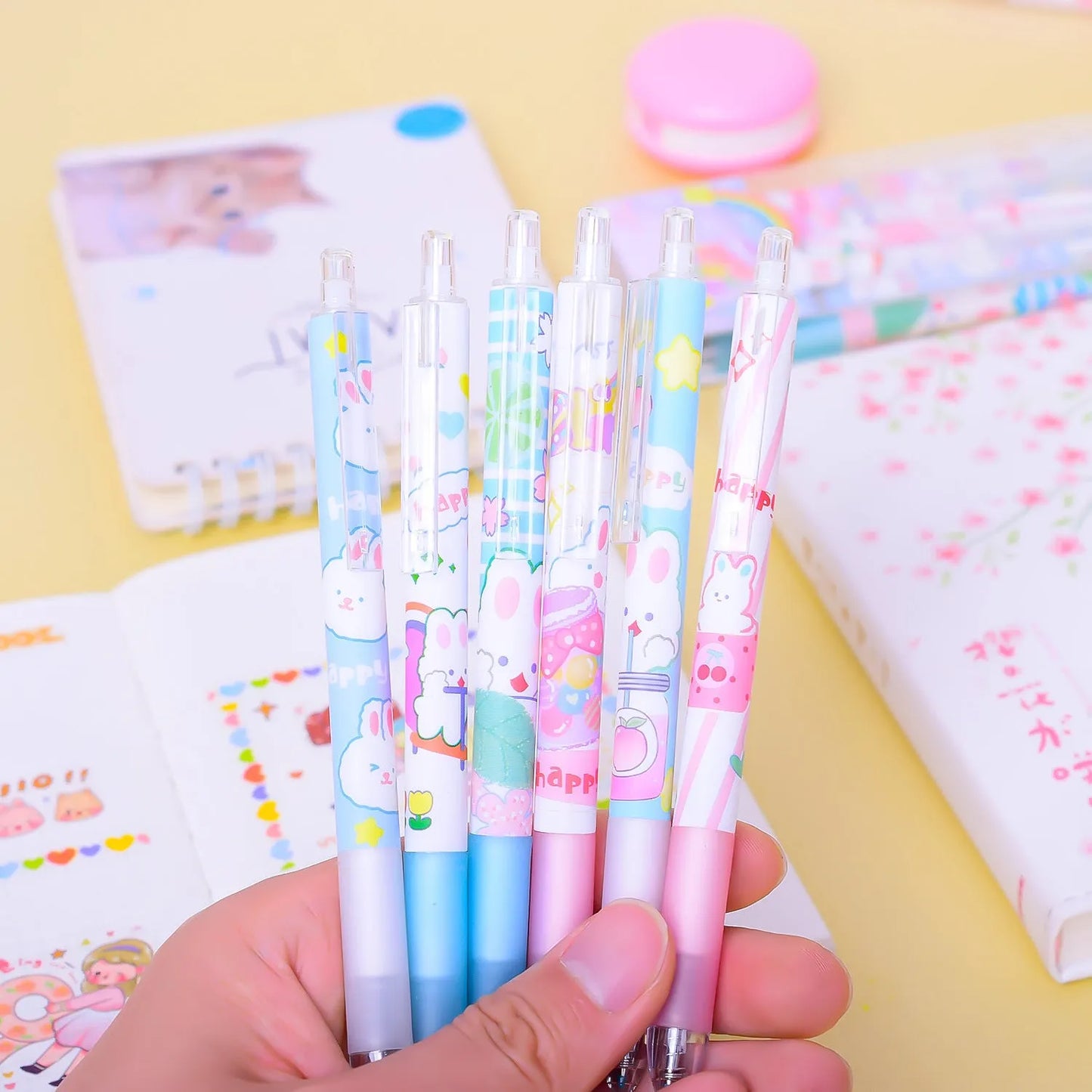 Six black ballpoint pens with cartoon bunny designs showing 0.5mm tips for writing