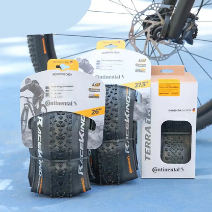 Mountain bike folding outer tyre with yellow sidewall, showing tread pattern and size label