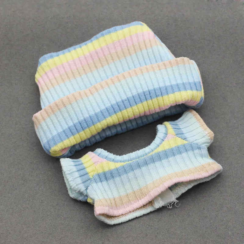 Doll clothes set with knitted flanging hat and T-shirt in multiple colours including pink, white, and stripes.