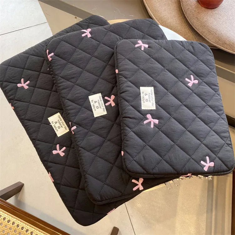 Nylon notebook storage bag with rhombus embroidery and bow, shown in light blue colour.