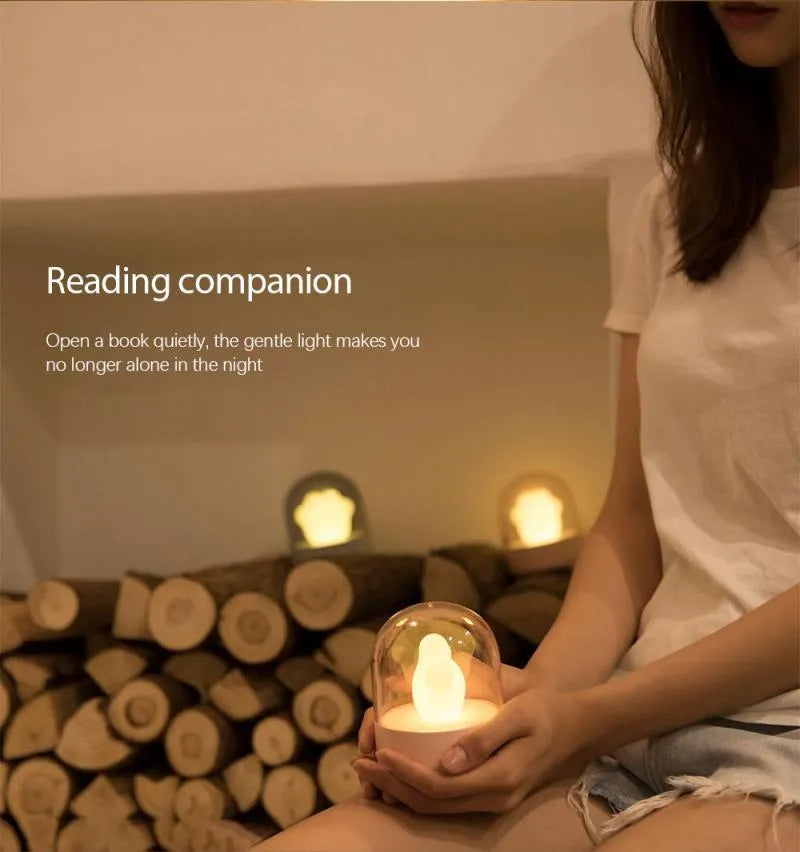 Grey cat paw shaped night light with USB port, sitting on a surface with soft glow.