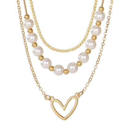Vintage gold heart pendant necklace on a textured pearl chain, adjustable 41-50cm length.