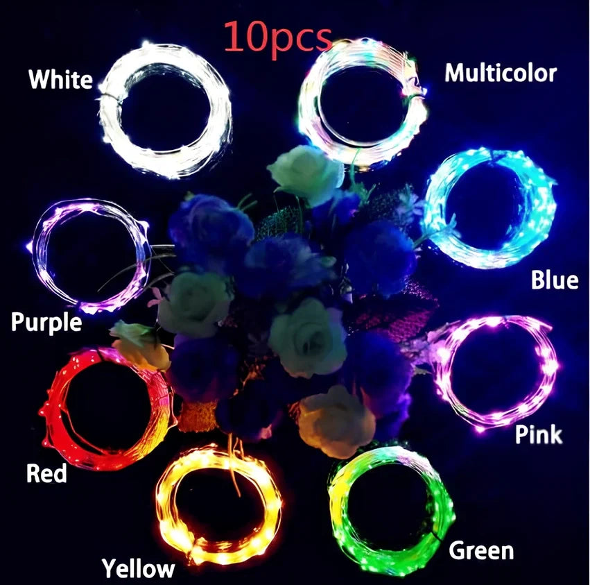 Copper wire LED string lights wrapped around wine bottle with 20 white LEDs illuminated