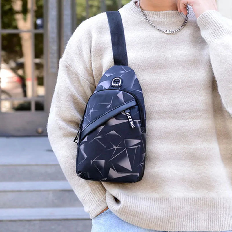 Men's sling chest bag in blue with earphone hole, crossbody strap, and zipper pockets, measuring 17cm wide.