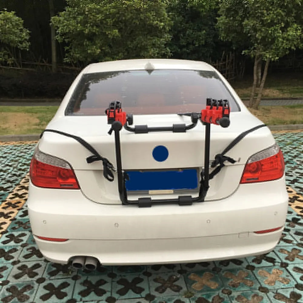 Black and red trunk mounted car bike holder rack with adjustable fastening system on vehicle boot