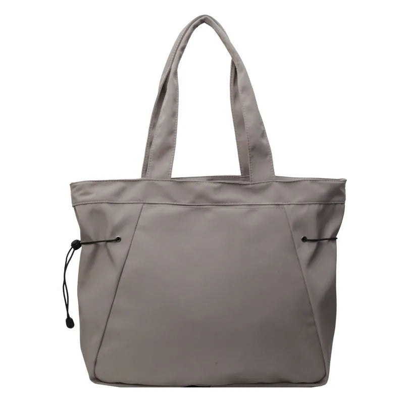 Soft Oxford cloth foldable commuter tote bag in street style, shown in multiple colour options.