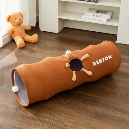 Collapsible brown or grey cat tunnel with a plush ball on top, shown in both extended and folded flat positions.