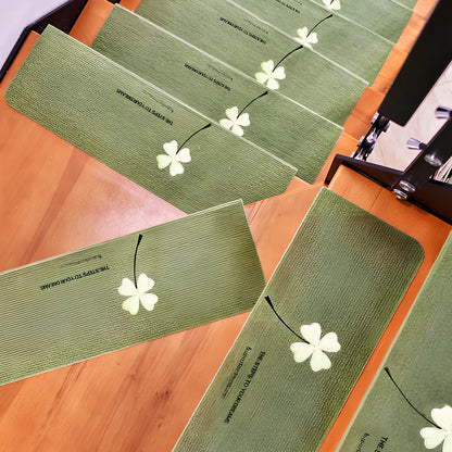 Self-adhesive luminous stair mat with glow strips on wooden staircase, rectangular design with hemmed edges