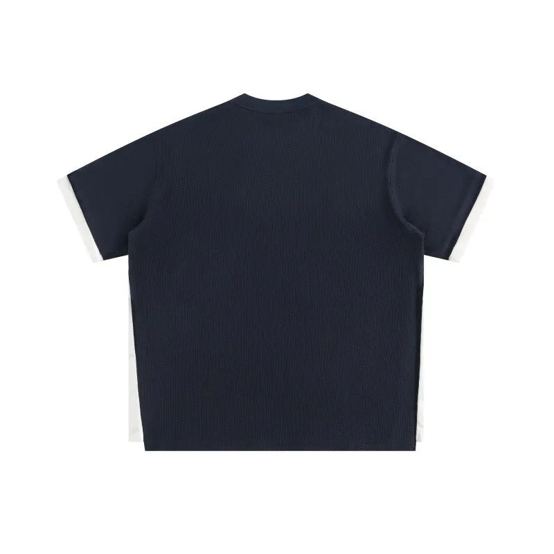 Navy blue loose waffle knit T-shirt with retro white alphabet embroidery on the chest.