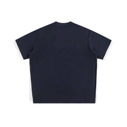 Navy blue loose waffle knit T-shirt with retro white alphabet embroidery on the chest.