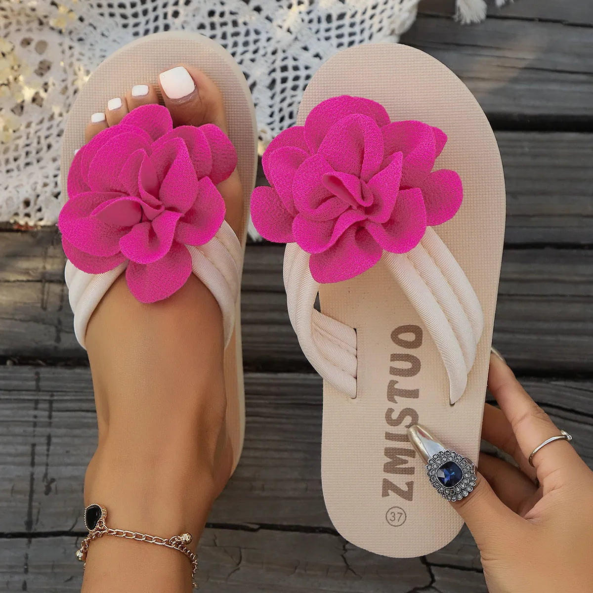 Women's plus size green PU flip flop slippers with flower pattern on a white background.